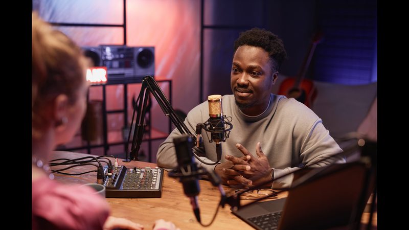 Podcast host listening to a guest in the studio